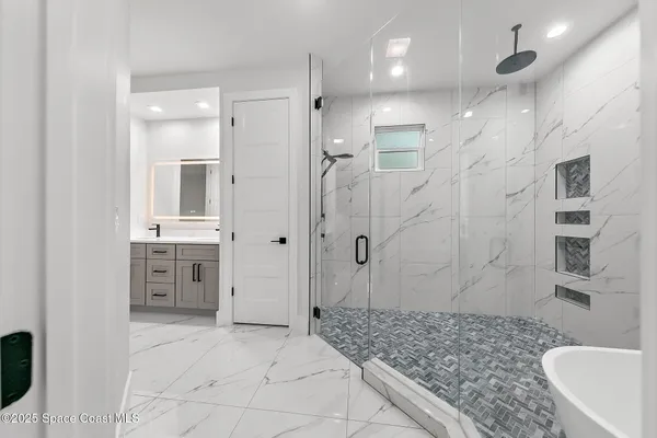 a bathroom with a toilet sink a shower and mirror