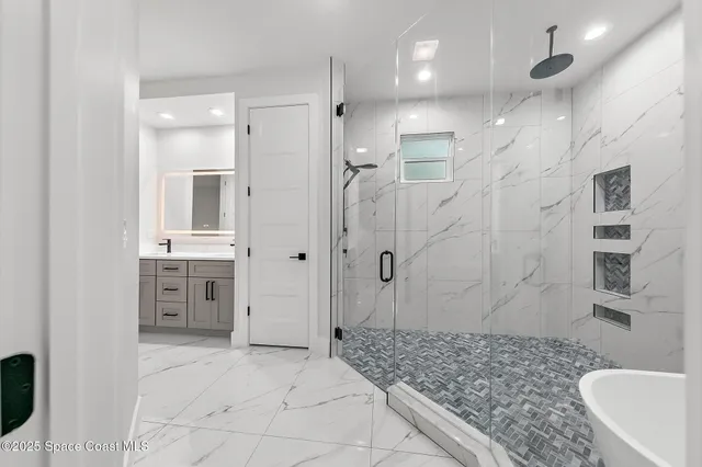 a bathroom with a toilet sink a shower and mirror