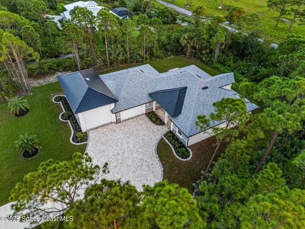 an aerial view of a house with a garden