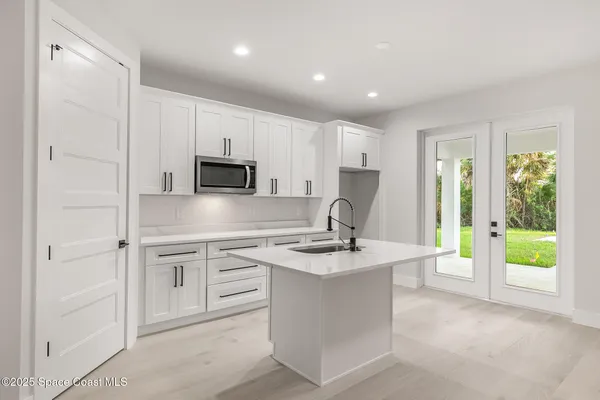 a view of a livingroom with a ceiling fan and window