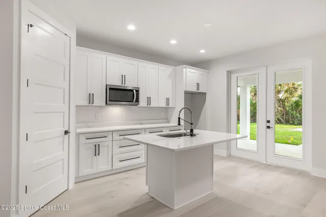 a view of a livingroom with a ceiling fan and window