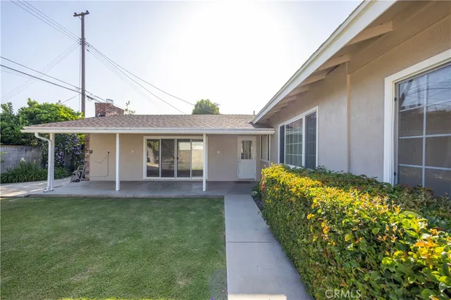 a front view of a house with a garden and plants