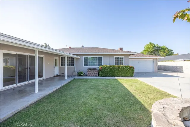 a view of a house with a yard and sitting area