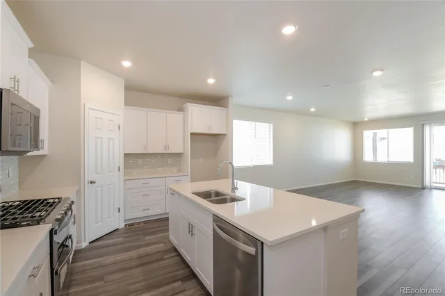 a kitchen with a sink stove and cabinets