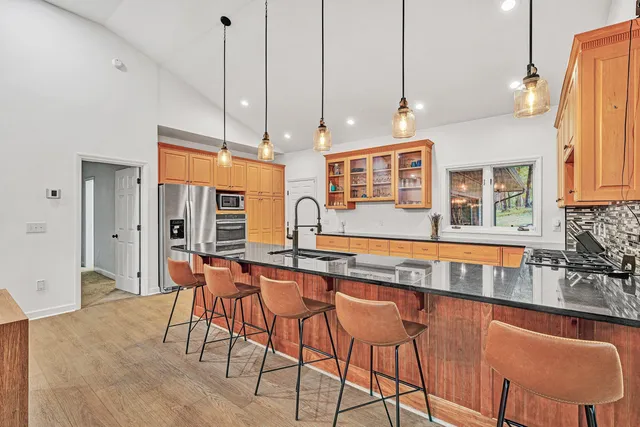 a kitchen with stainless steel appliances a sink stove and cabinets