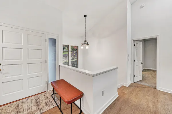 a living room with a table chairs and a flat screen tv