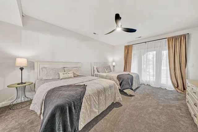 a view of a patio with table and chairs under an umbrella