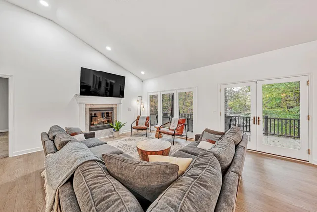 a living room with furniture a fireplace and a flat screen tv