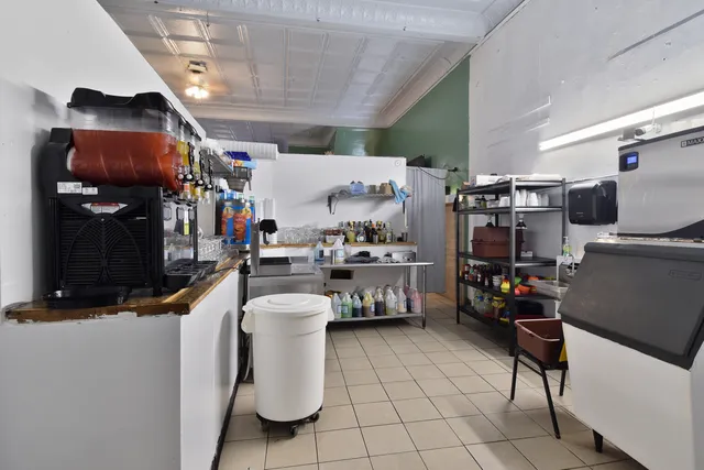 a kitchen with a sink a stove and chairs
