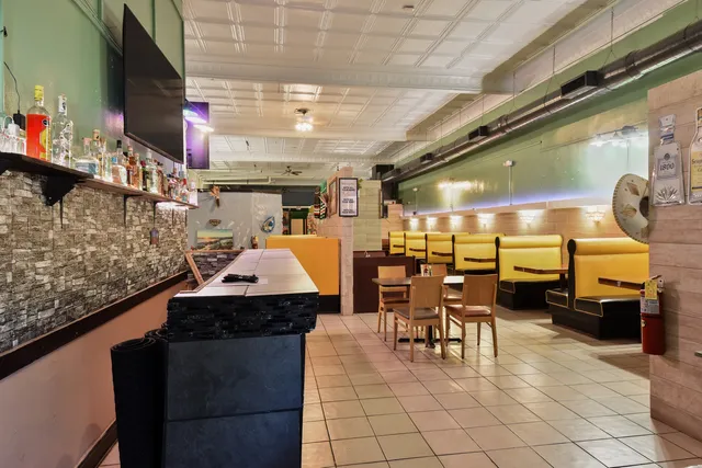 a kitchen with stainless steel appliances kitchen island granite countertop a sink and a microwave