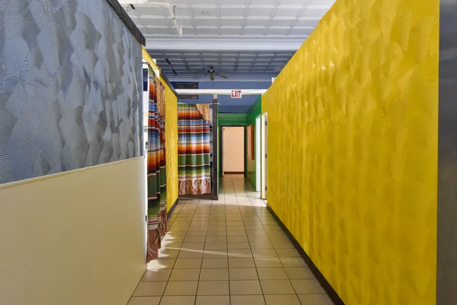 a view of a room with wooden floor and windows