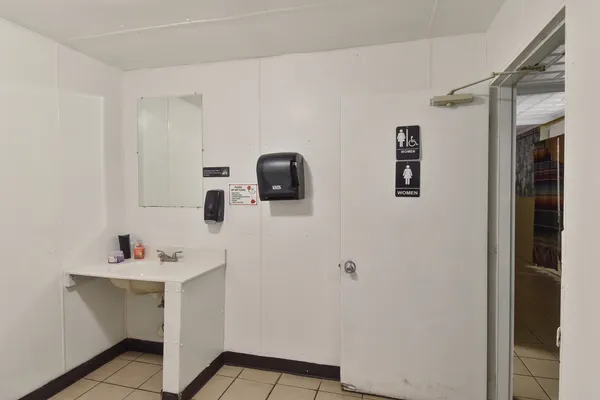 a bathroom with a sink a mirror and vanity