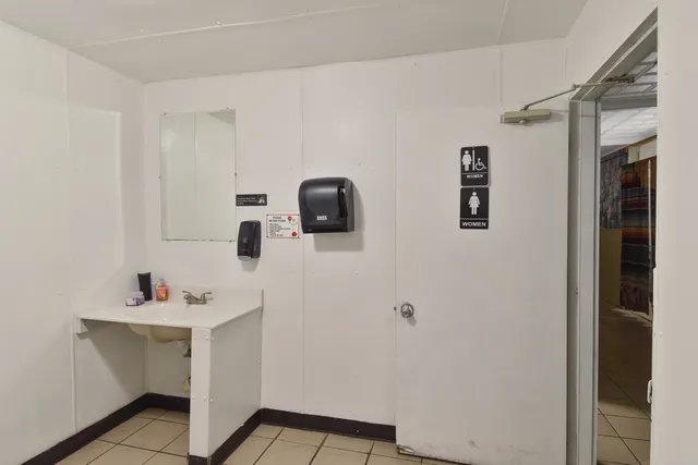 a bathroom with a sink a mirror and vanity