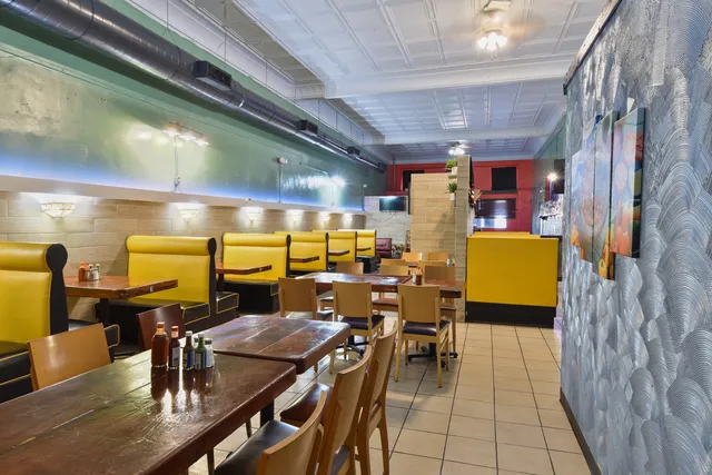 a kitchen with a table chairs and refrigerator