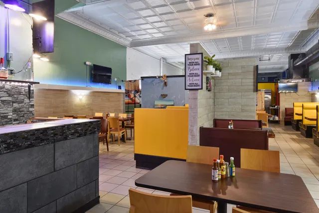 a kitchen with lots of clutter and stainless steel appliances