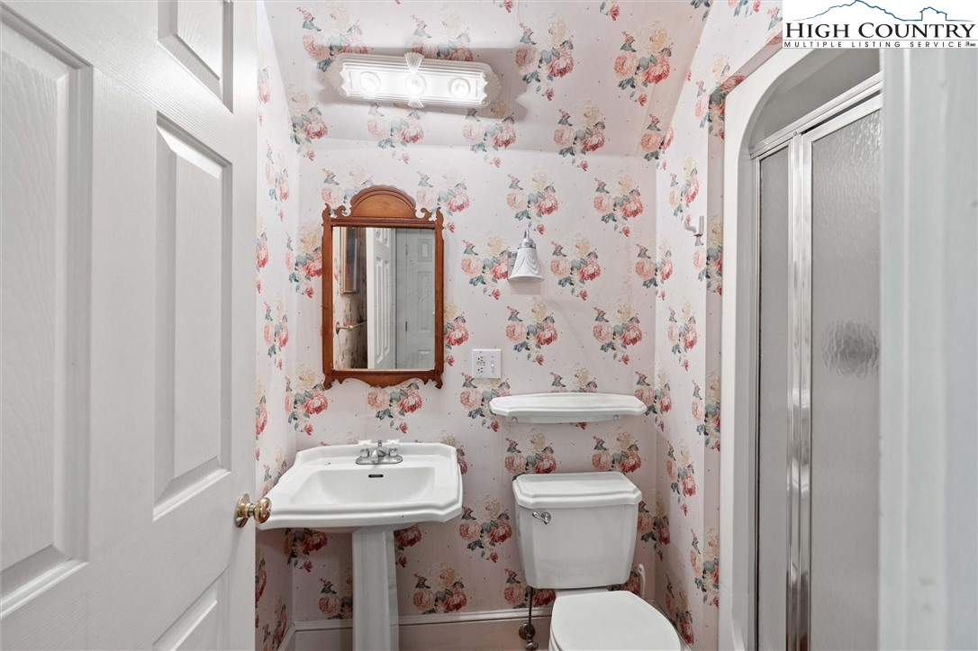 208 Hawkbill Road Ferguson, NC 28624 - Photo 22 of 36 a bathroom with a sink a toilet and shower curtain