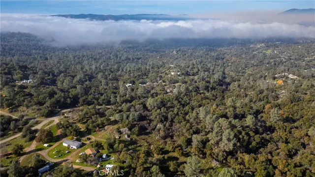 an aerial view of residential house and car parked