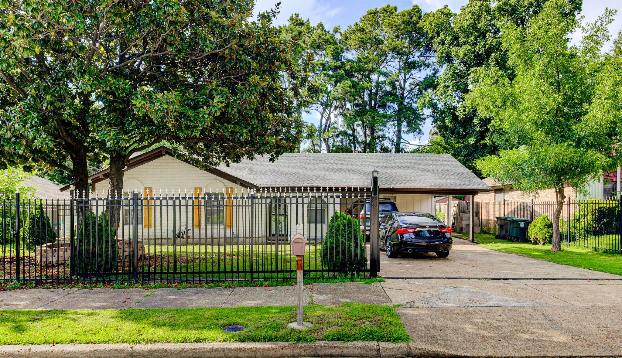 6044 Raintree Drive Memphis, TN 38115 - Photo 3 of 22 Single story home with a fenced front yard, concrete driveway, and roof with shingles