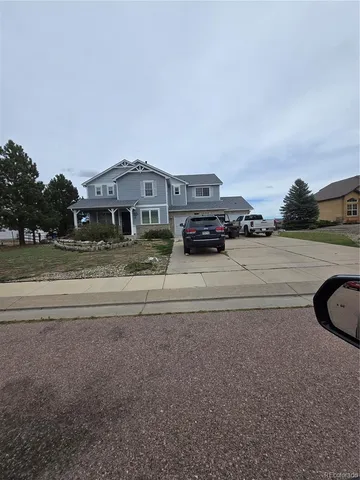 a view of a house with a yard and sitting area