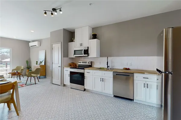 a kitchen with stainless steel appliances granite countertop a stove and a sink