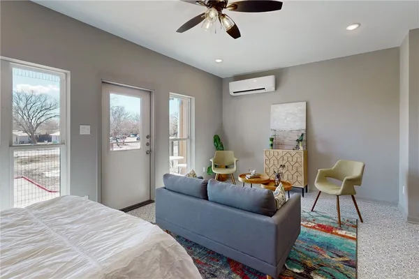 a bedroom with a bed and a painting on the wall