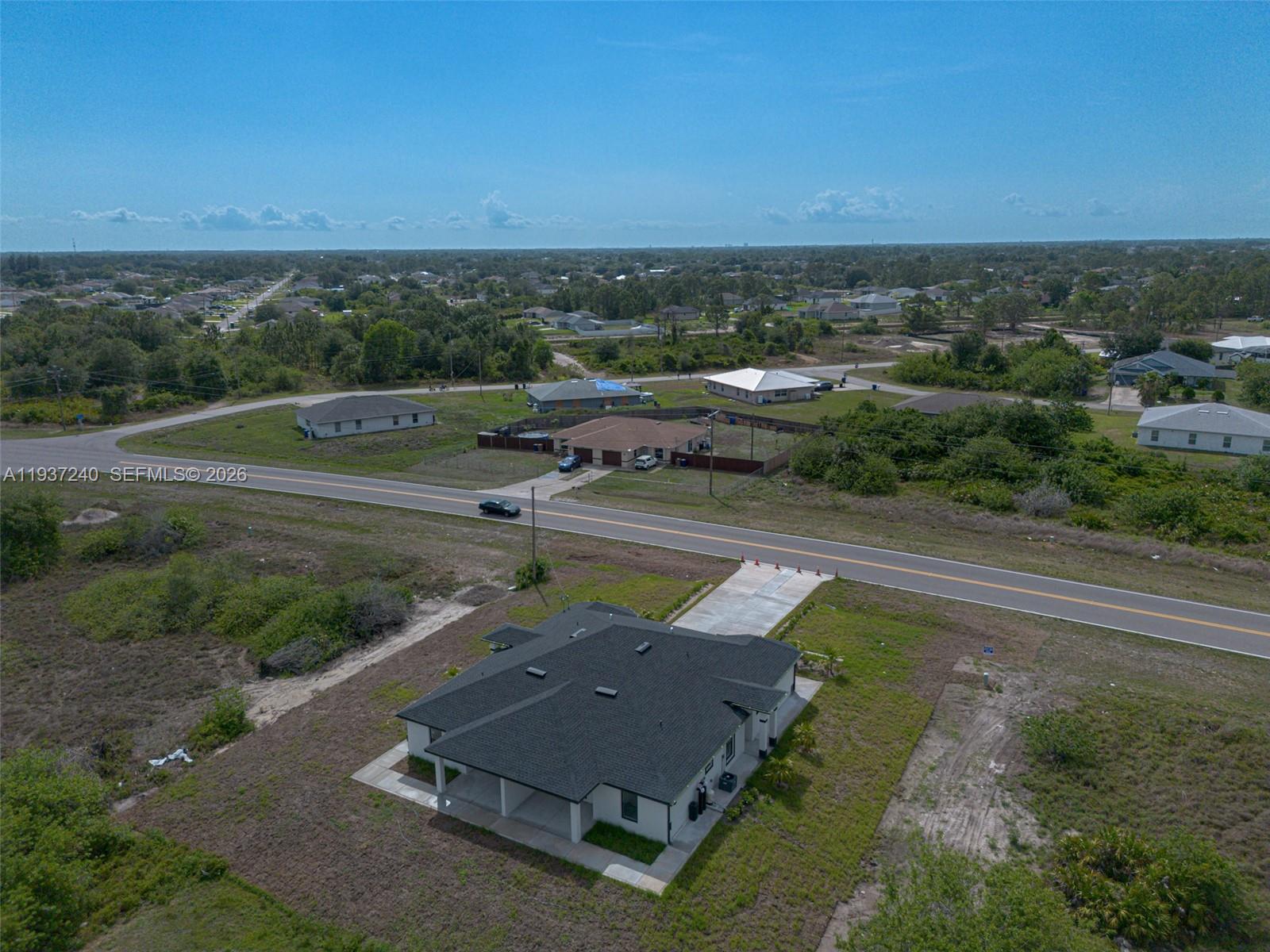 842-844 Alabama Road South Lehigh Acres, FL 33974 - Photo 11 of 40 an aerial view of a house with a yard