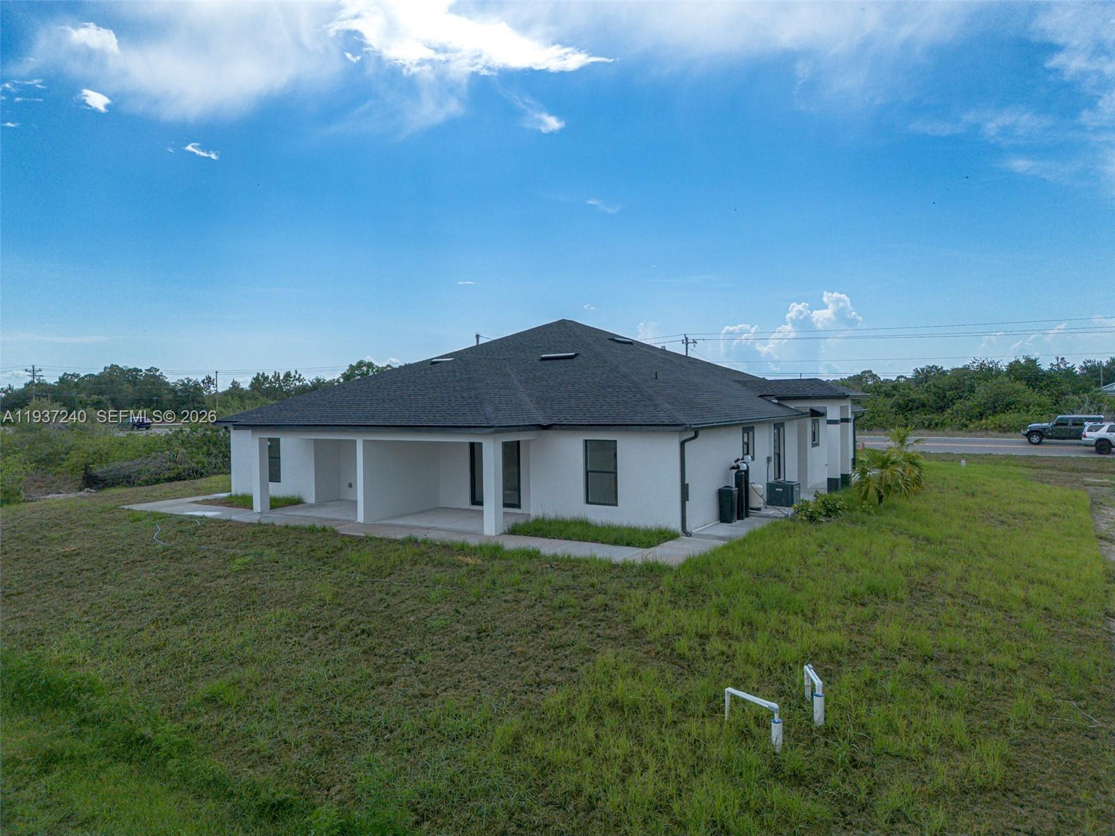 842-844 Alabama Road South Lehigh Acres, FL 33974 - Photo 2 of 40 a view of a house with a big yard