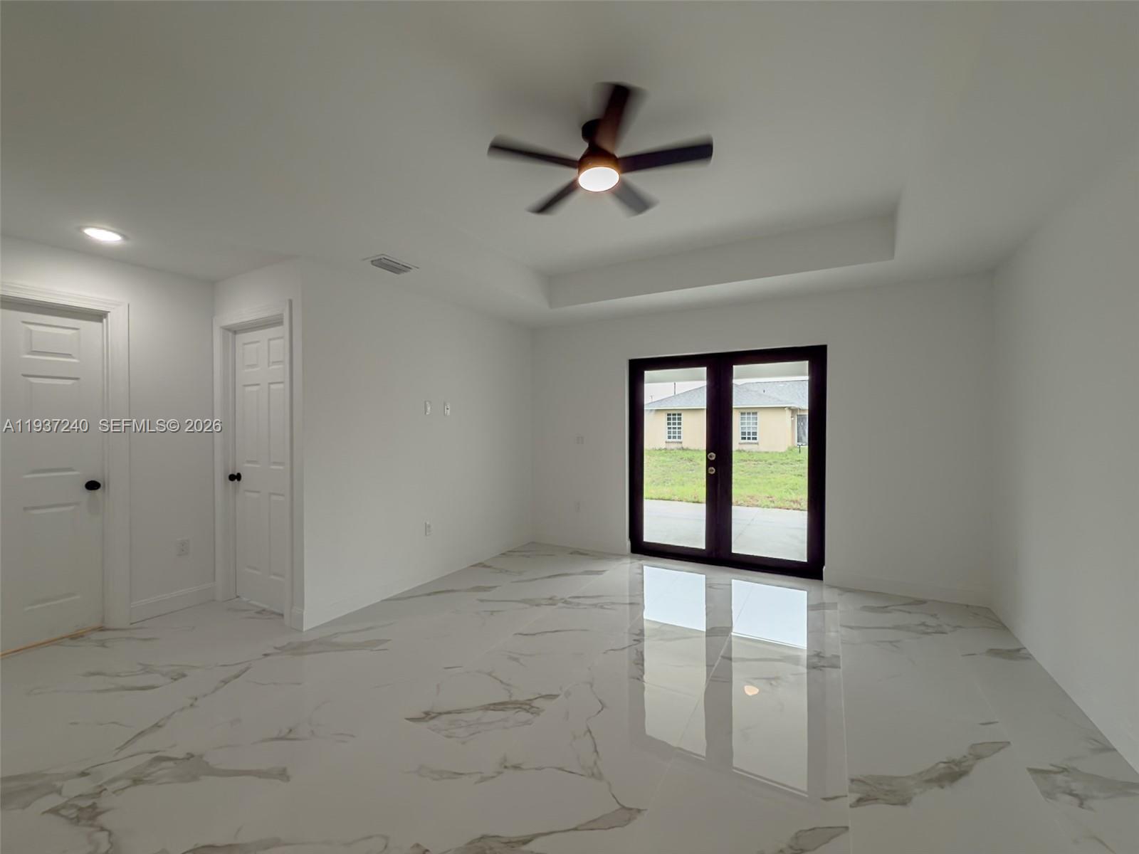 842-844 Alabama Road South Lehigh Acres, FL 33974 - Photo 21 of 40 a view of a livingroom with a ceiling fan and window