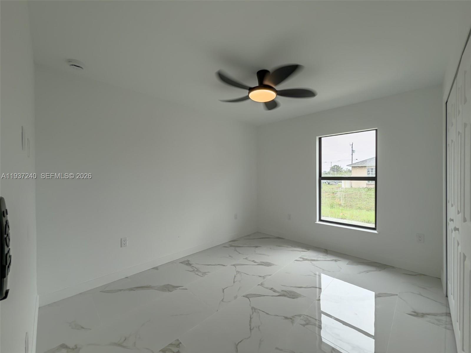 842-844 Alabama Road South Lehigh Acres, FL 33974 - Photo 23 of 40 an empty room with windows and fan
