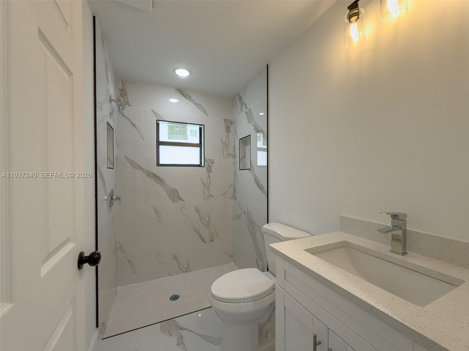 842-844 Alabama Road South Lehigh Acres, FL 33974 - Photo 26 of 40 a bathroom with a sink toilet and shower