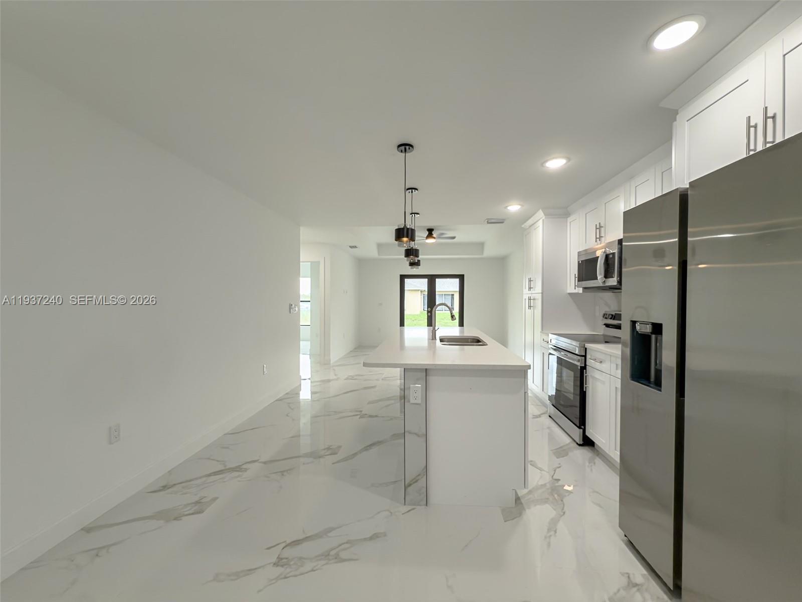 842-844 Alabama Road South Lehigh Acres, FL 33974 - Photo 33 of 40 a kitchen with refrigerator and window