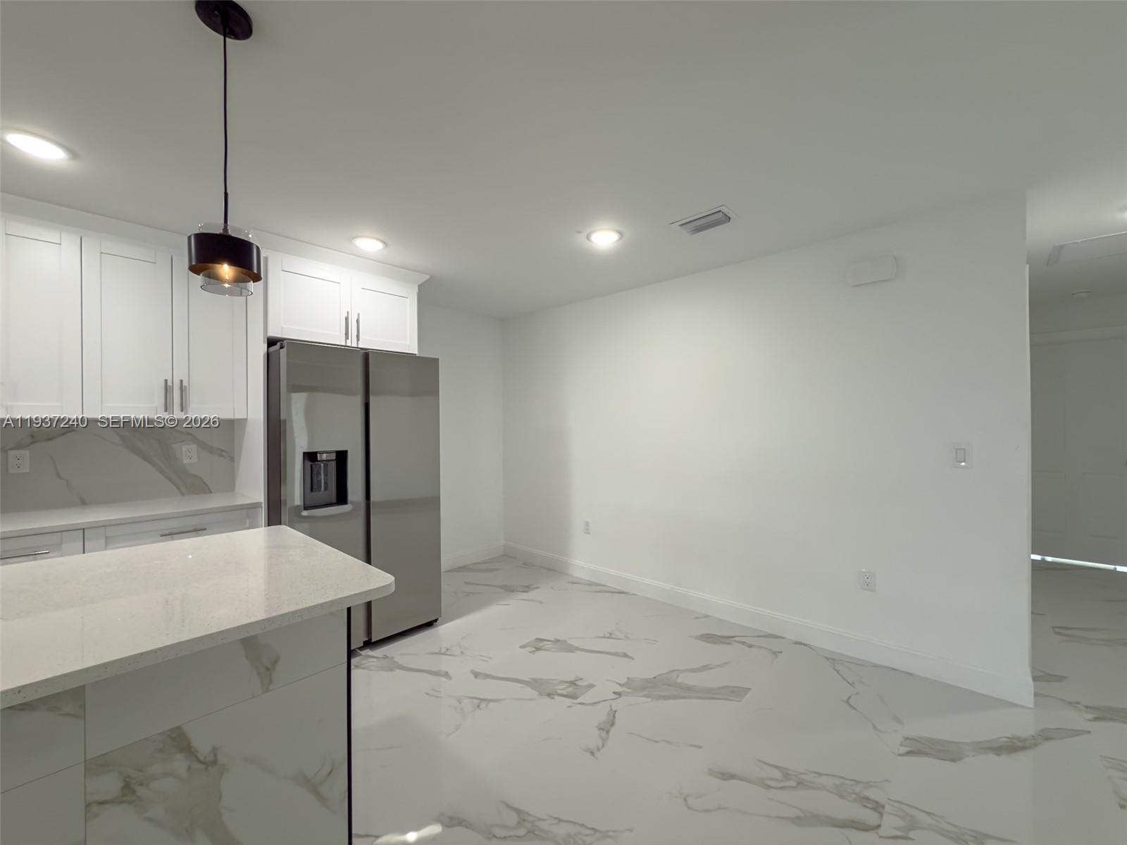 842-844 Alabama Road South Lehigh Acres, FL 33974 - Photo 39 of 40 a view of a kitchen with a refrigerator and a sink