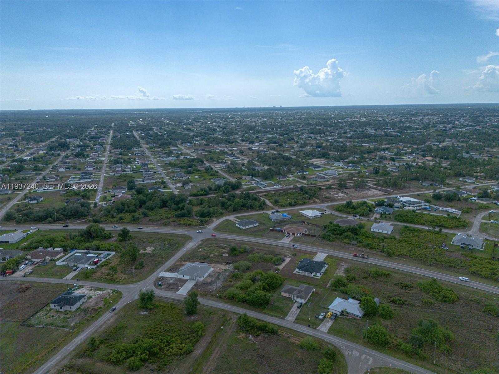842-844 Alabama Road South Lehigh Acres, FL 33974 - Photo 4 of 40 an aerial view of residential houses with outdoor space and trees