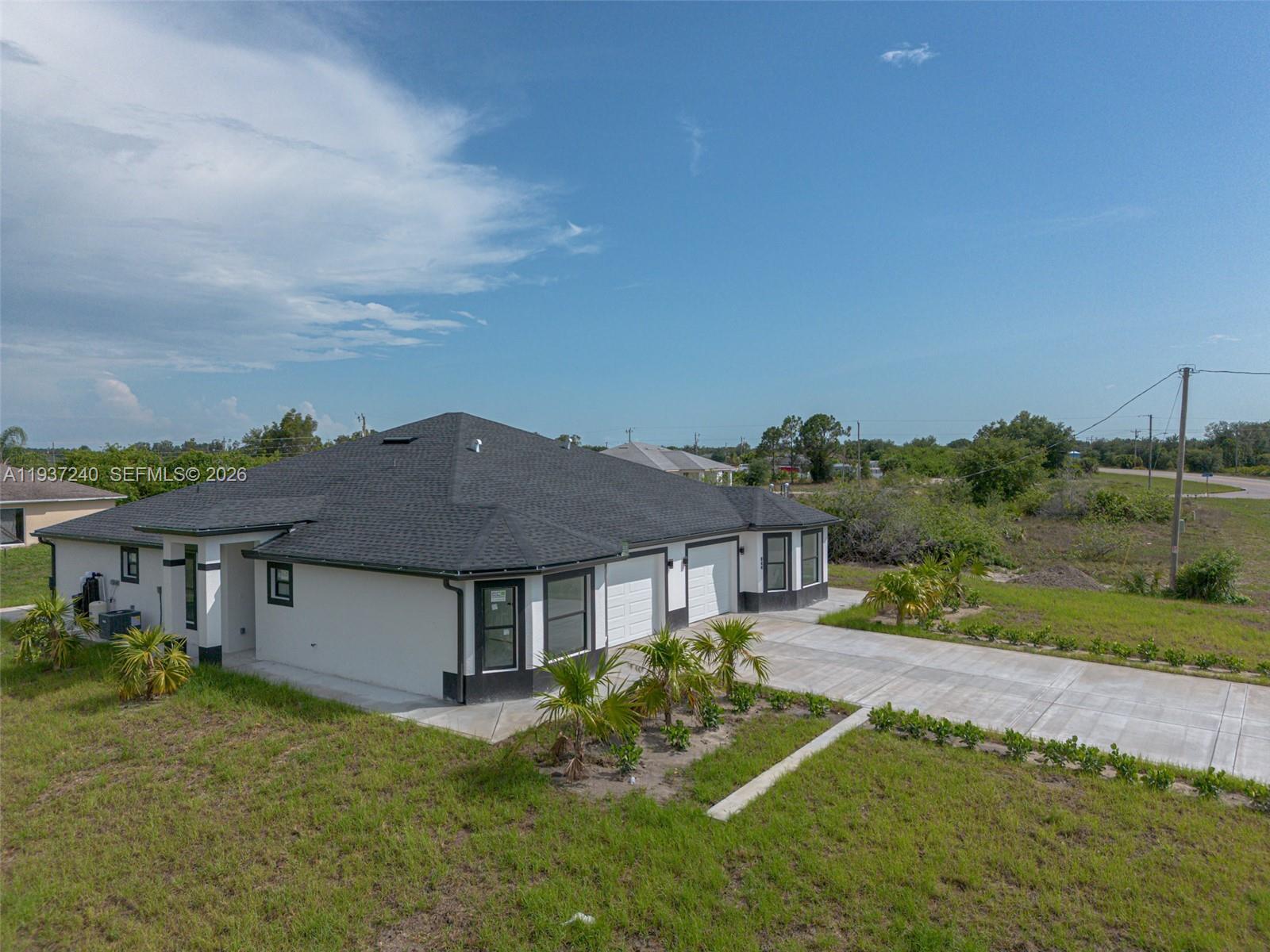 842-844 Alabama Road South Lehigh Acres, FL 33974 - Photo 9 of 40 a front view of a house with a yard table and chairs