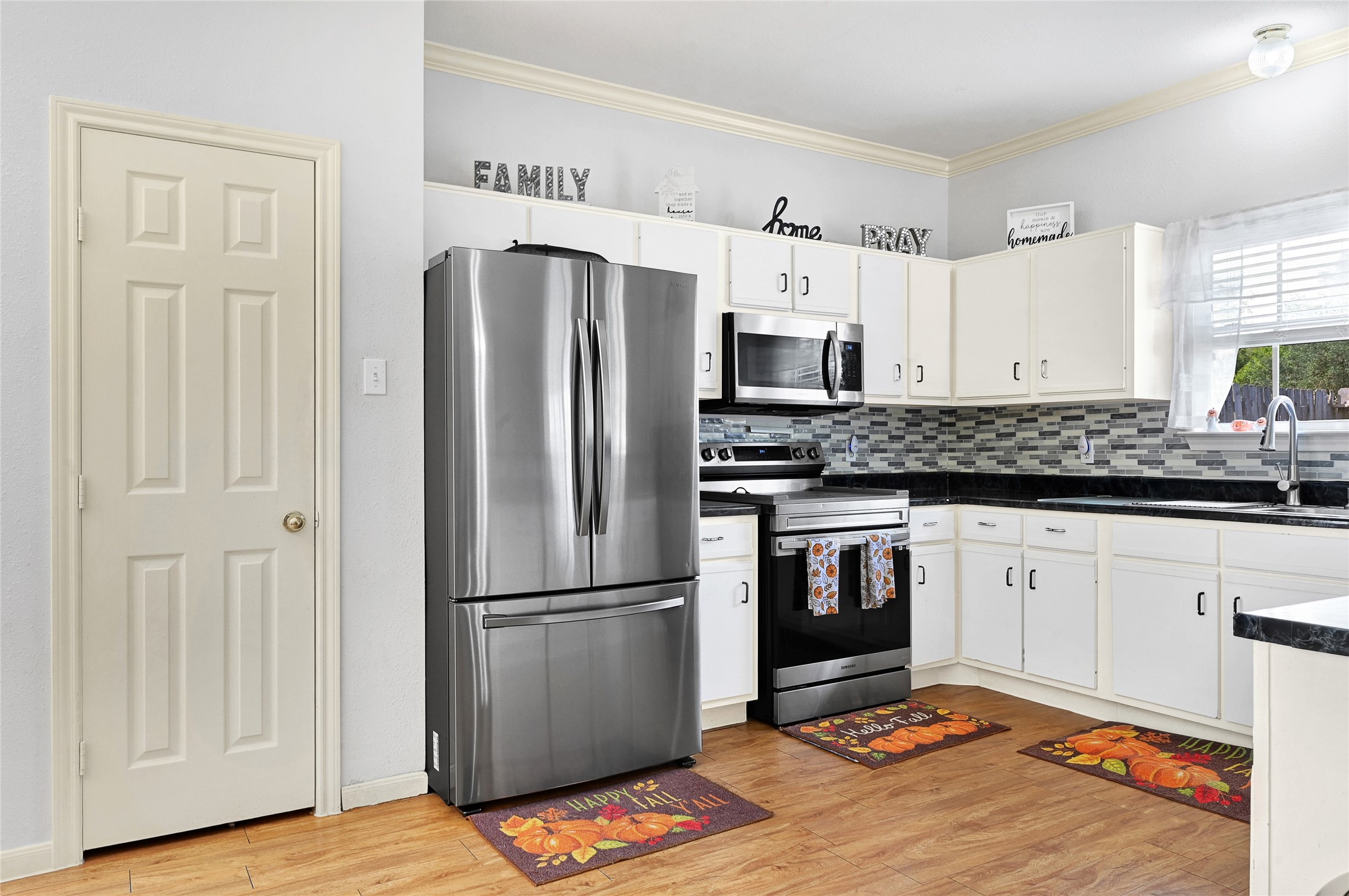 10100 Spring Pl Drive Houston, TX 77070 - Photo 7 of 24 Functional kitchen layout with ample counter space and convenient access to adjacent areas.