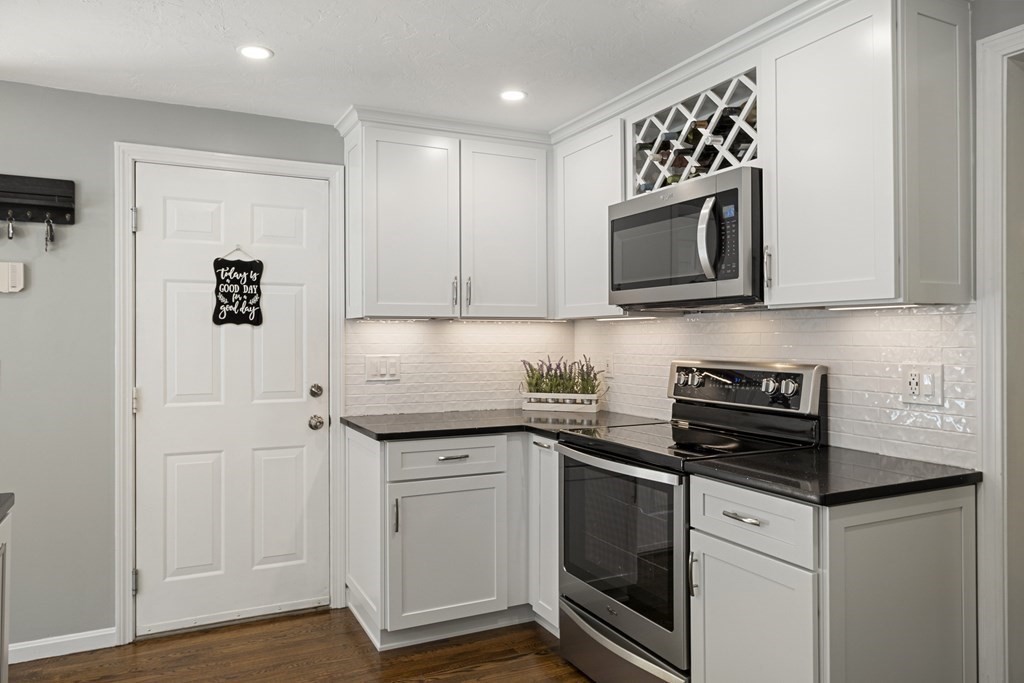 23 Taft Avenue Maynard, MA 01754 - Photo 11 of 42 a kitchen with granite countertop cabinets stainless steel appliances and wooden floor