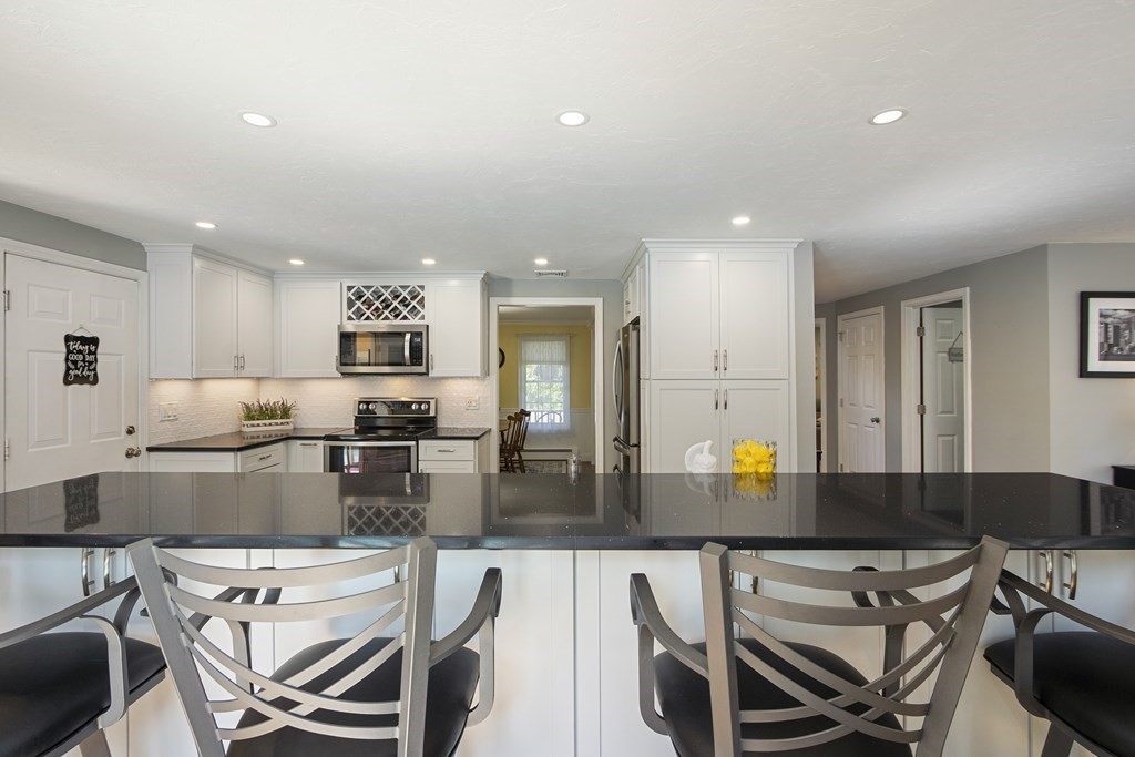 23 Taft Avenue Maynard, MA 01754 - Photo 12 of 42 a kitchen with a table chairs stove and refrigerator