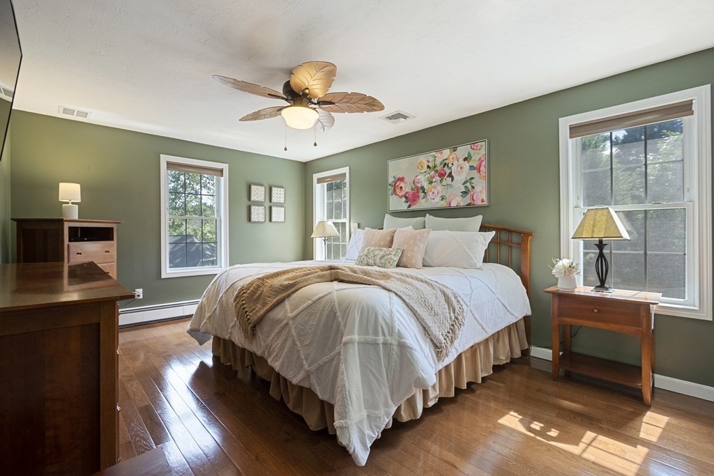 23 Taft Avenue Maynard, MA 01754 - Photo 20 of 42 a spacious bedroom with a bed and a chandelier