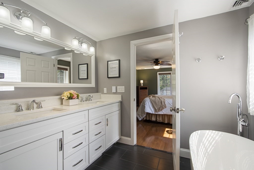 23 Taft Avenue Maynard, MA 01754 - Photo 24 of 42 a en suite bathroom with a granite countertop tub and a mirror