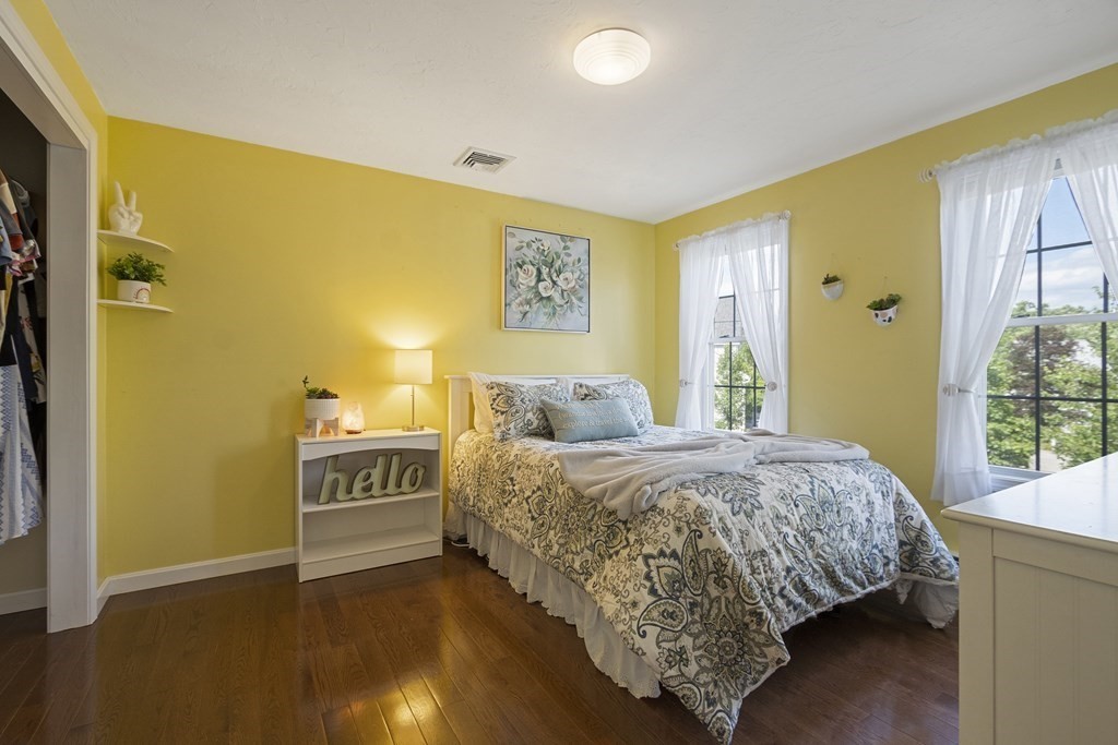 23 Taft Avenue Maynard, MA 01754 - Photo 28 of 42 a spacious bedroom with a bed and wooden floor