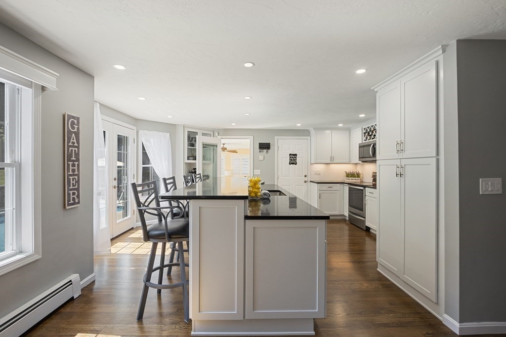 23 Taft Avenue Maynard, MA 01754 - Photo 8 of 42 a living room with furniture a dining table and chairs