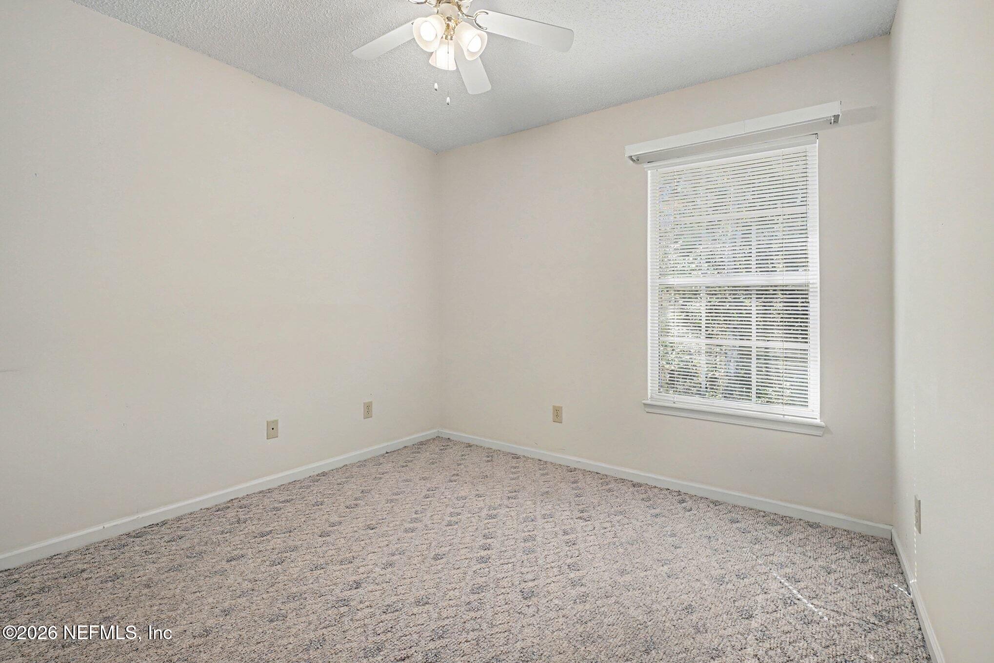 11958 Swooping Willow Road Jacksonville, FL 32223 - Photo 19 of 31 an empty room with a window