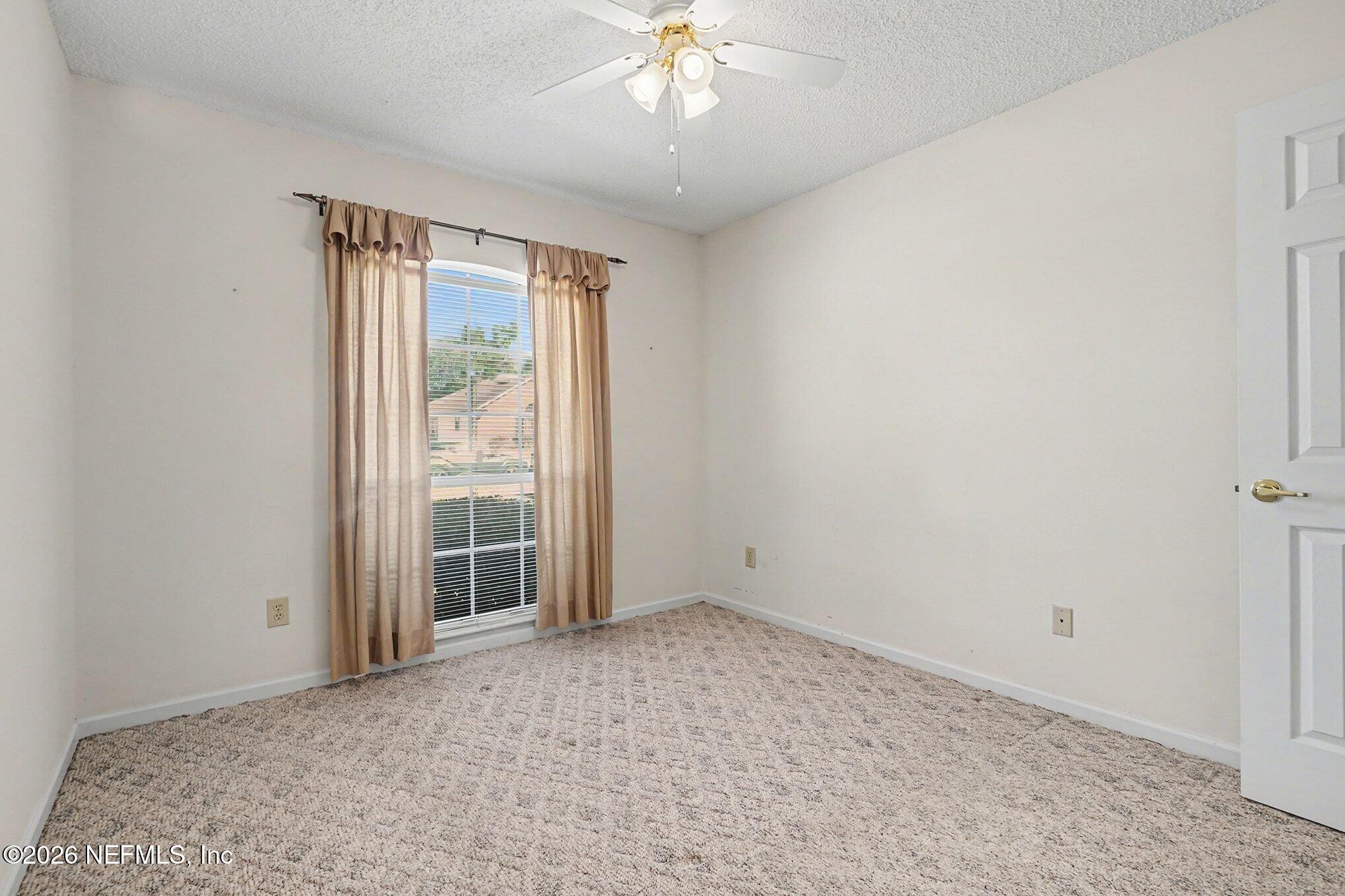 11958 Swooping Willow Road Jacksonville, FL 32223 - Photo 23 of 31 a view of an empty room with a window
