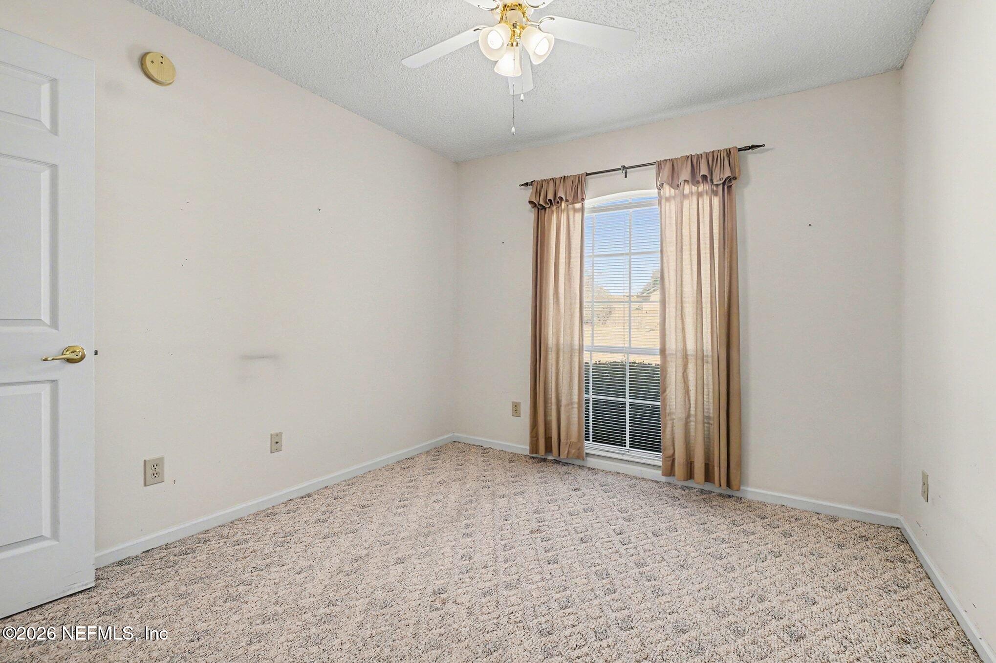 11958 Swooping Willow Road Jacksonville, FL 32223 - Photo 24 of 31 a view of an empty room with a window