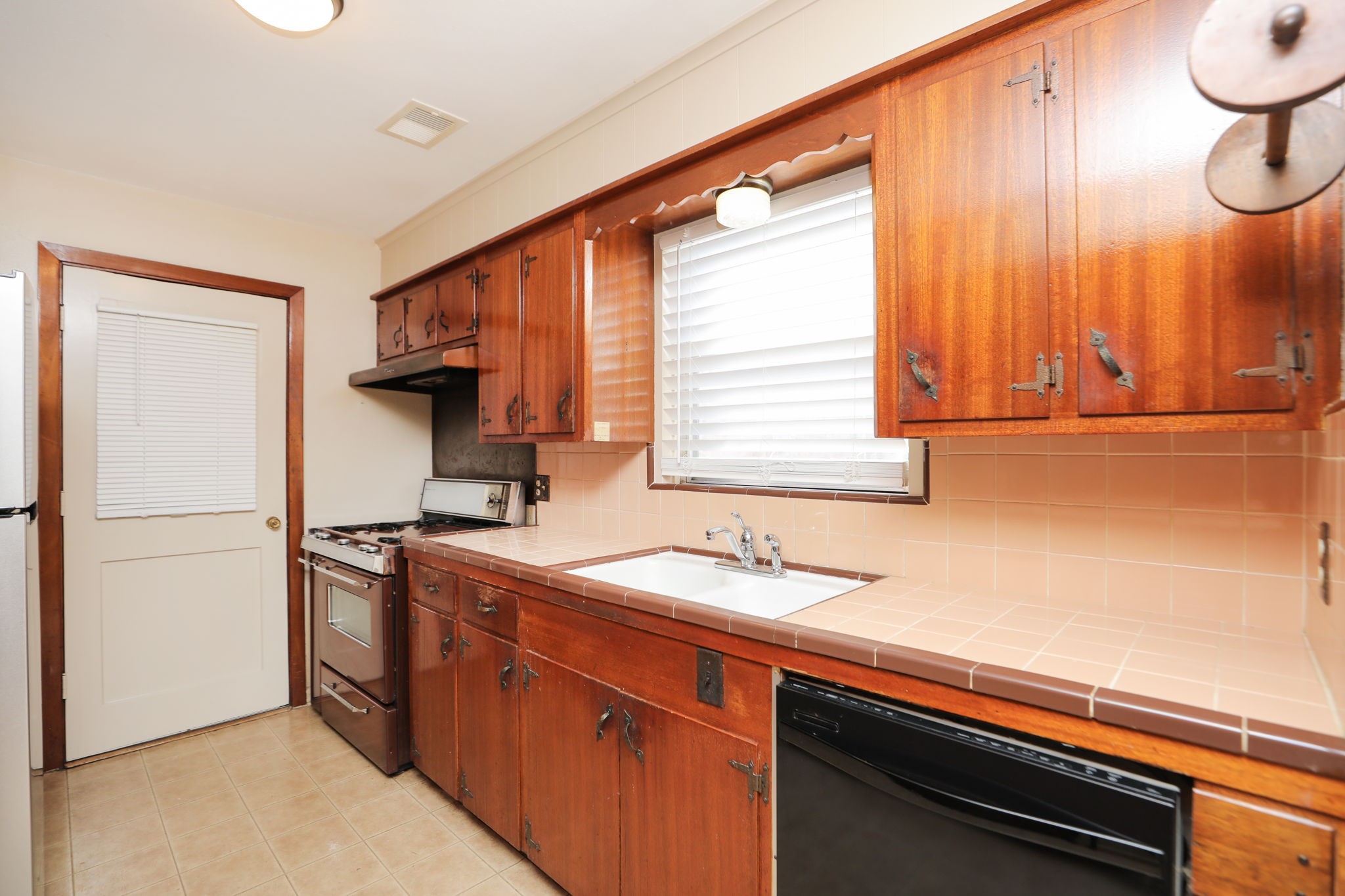 7158 Sharpview Drive Houston, TX 77074 - Photo 17 of 35 a kitchen with stainless steel appliances a sink cabinets and a window