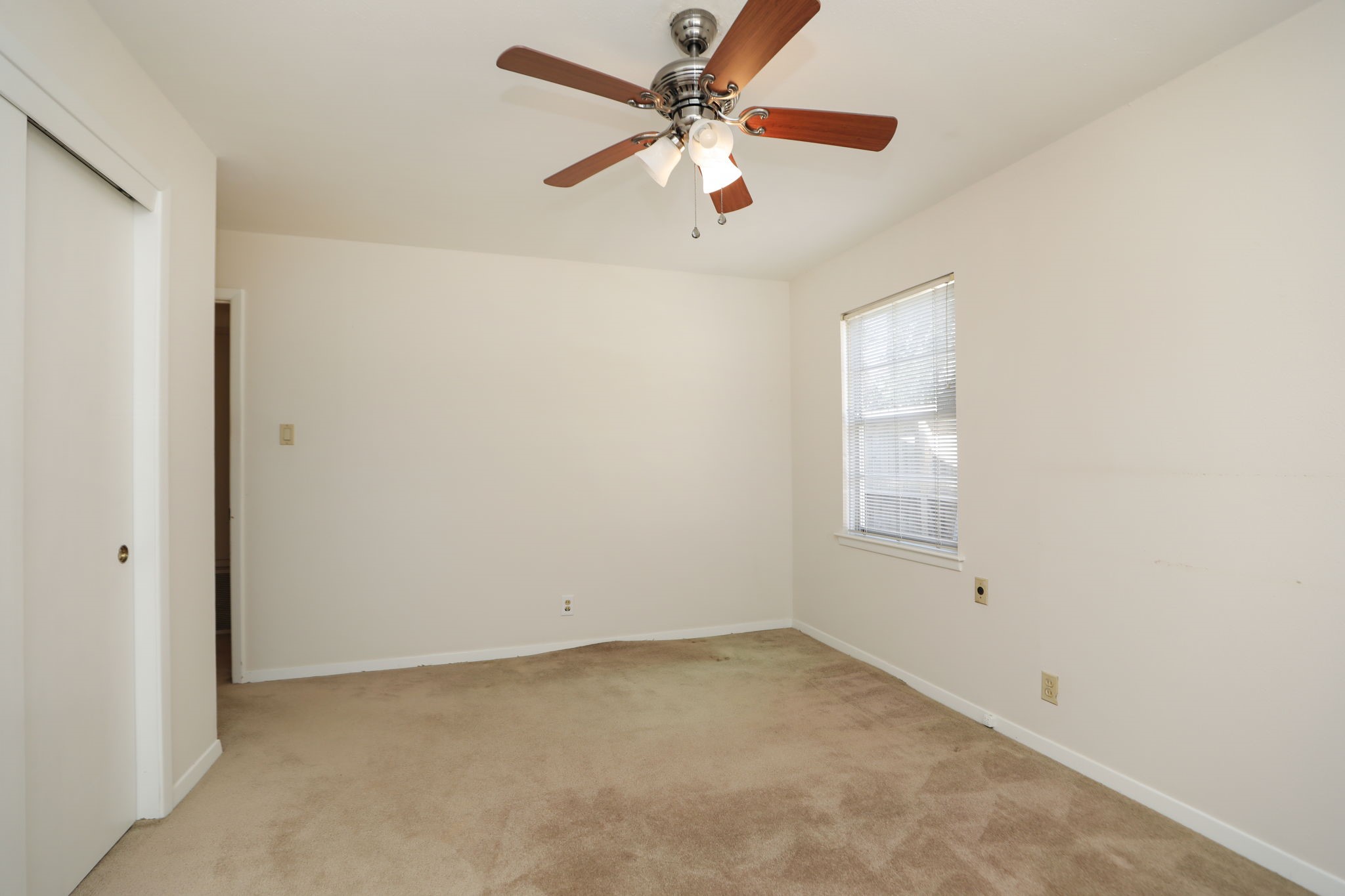 7158 Sharpview Drive Houston, TX 77074 - Photo 24 of 35 an empty room with a window and a fan
