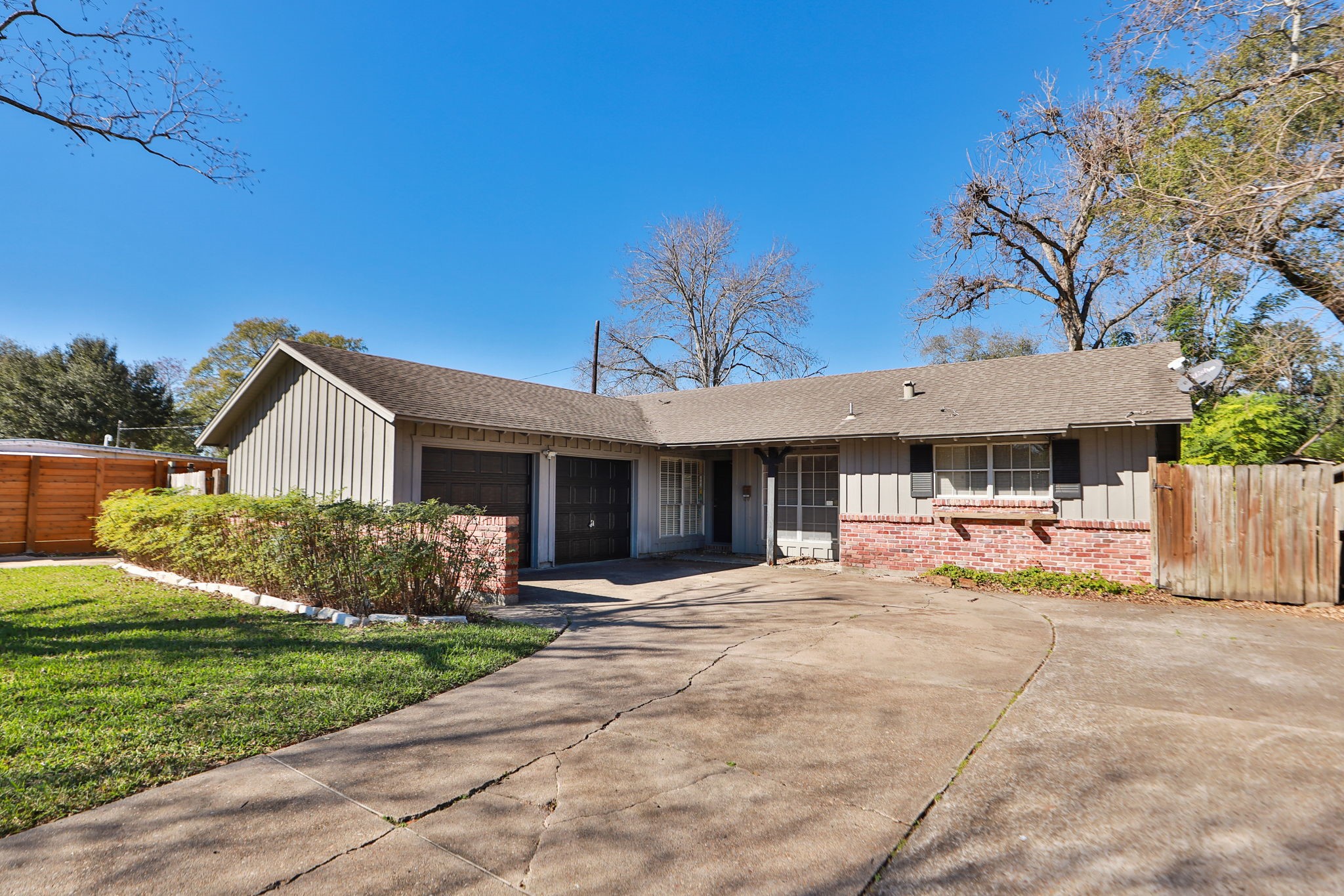 7158 Sharpview Drive Houston, TX 77074 - Photo 4 of 35 a front view of a house with a yard and garage