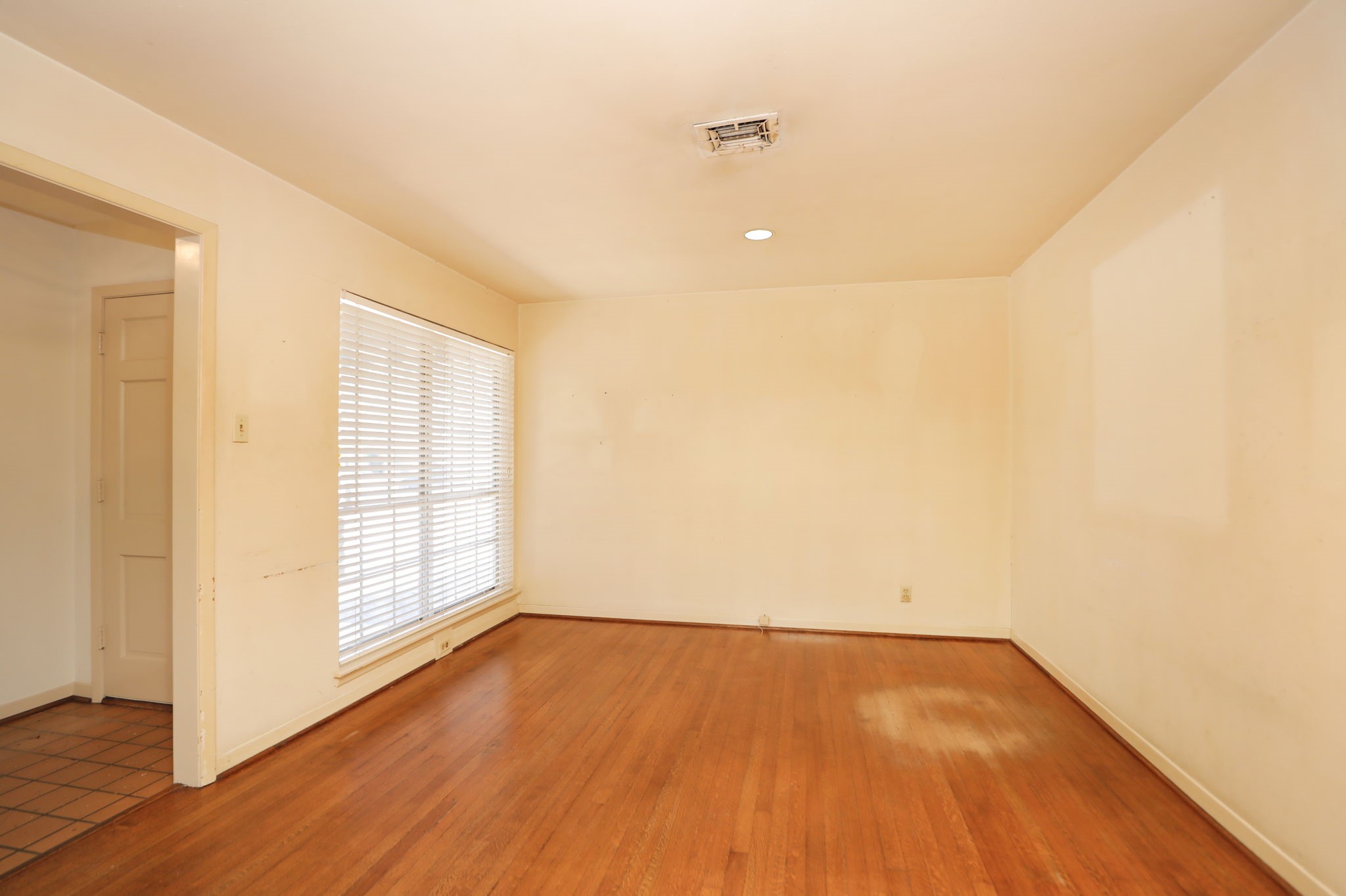 7158 Sharpview Drive Houston, TX 77074 - Photo 8 of 35 an empty room with wooden floor and windows