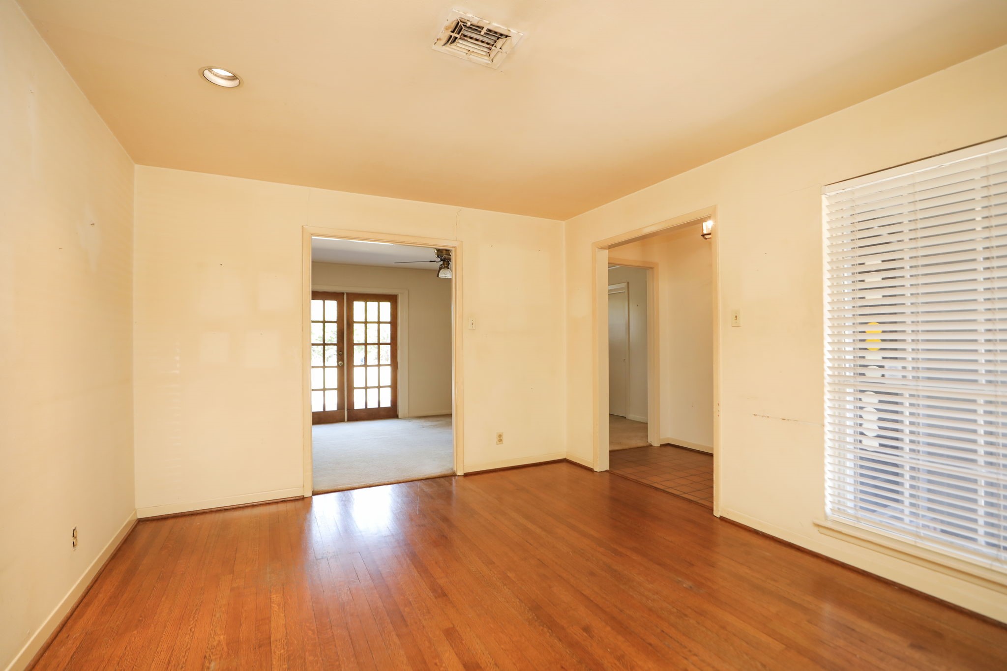 7158 Sharpview Drive Houston, TX 77074 - Photo 9 of 35 a view of an empty room with wooden floor and a window