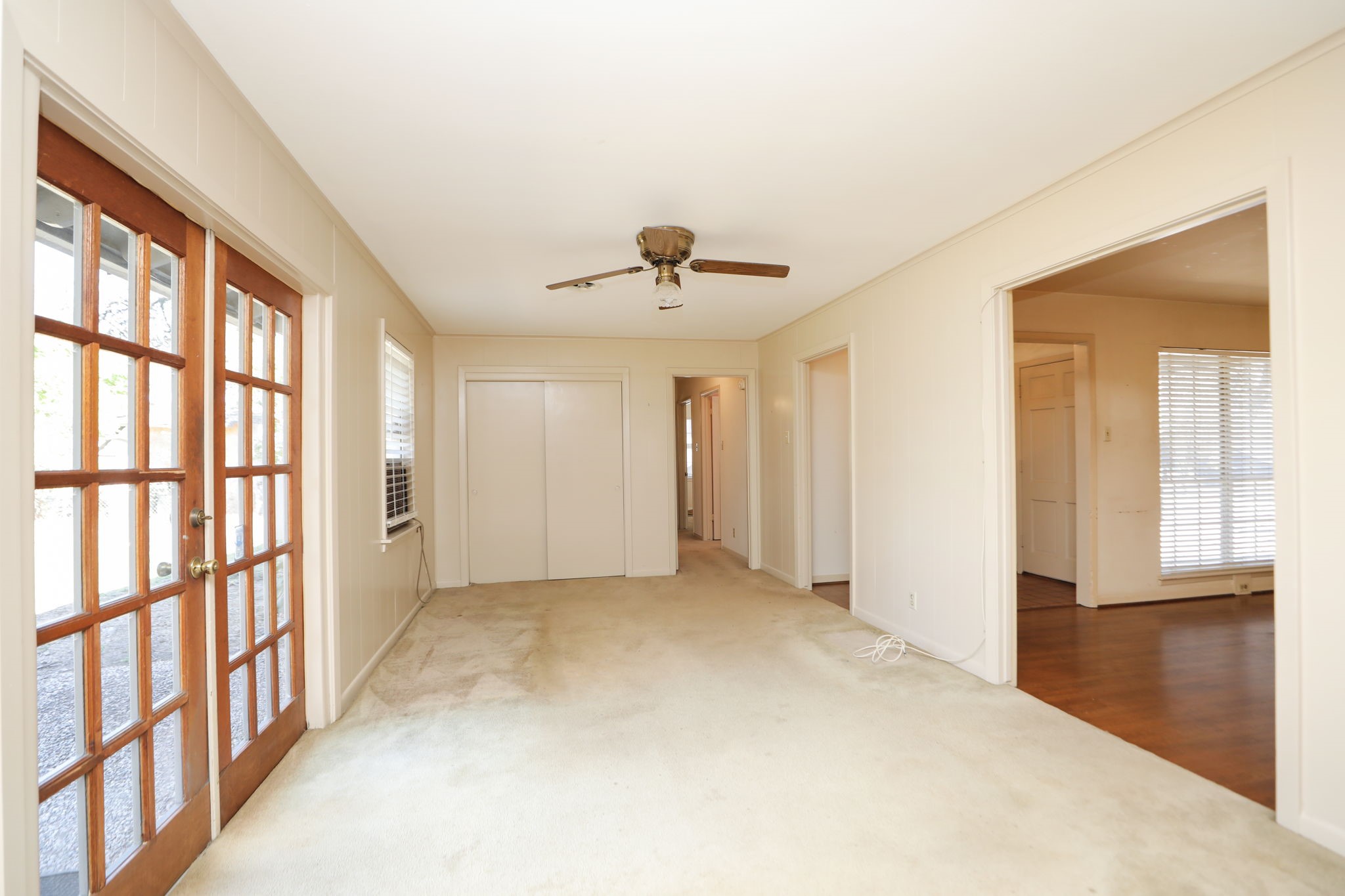 7158 Sharpview Drive Houston, TX 77074 - Photo 10 of 35 a view of empty room with wooden floor and fan
